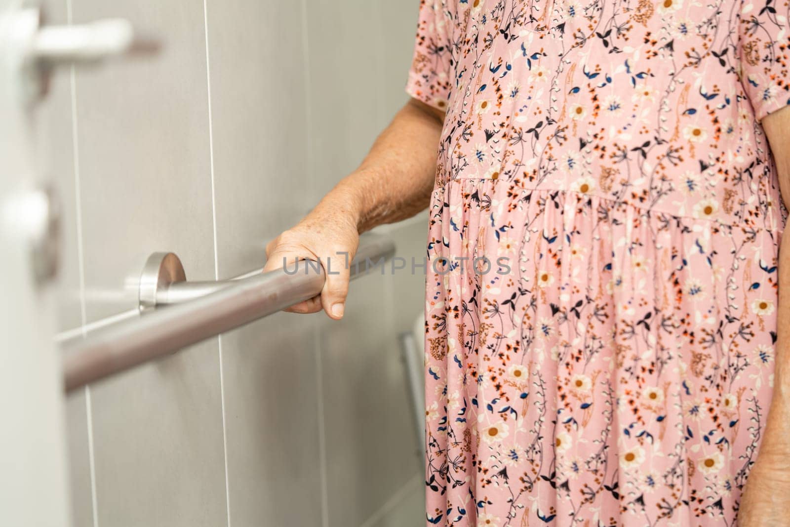 Asian elderly woman patient use toilet bathroom handle security in nursing hospital, healthy strong medical concept. by pamai