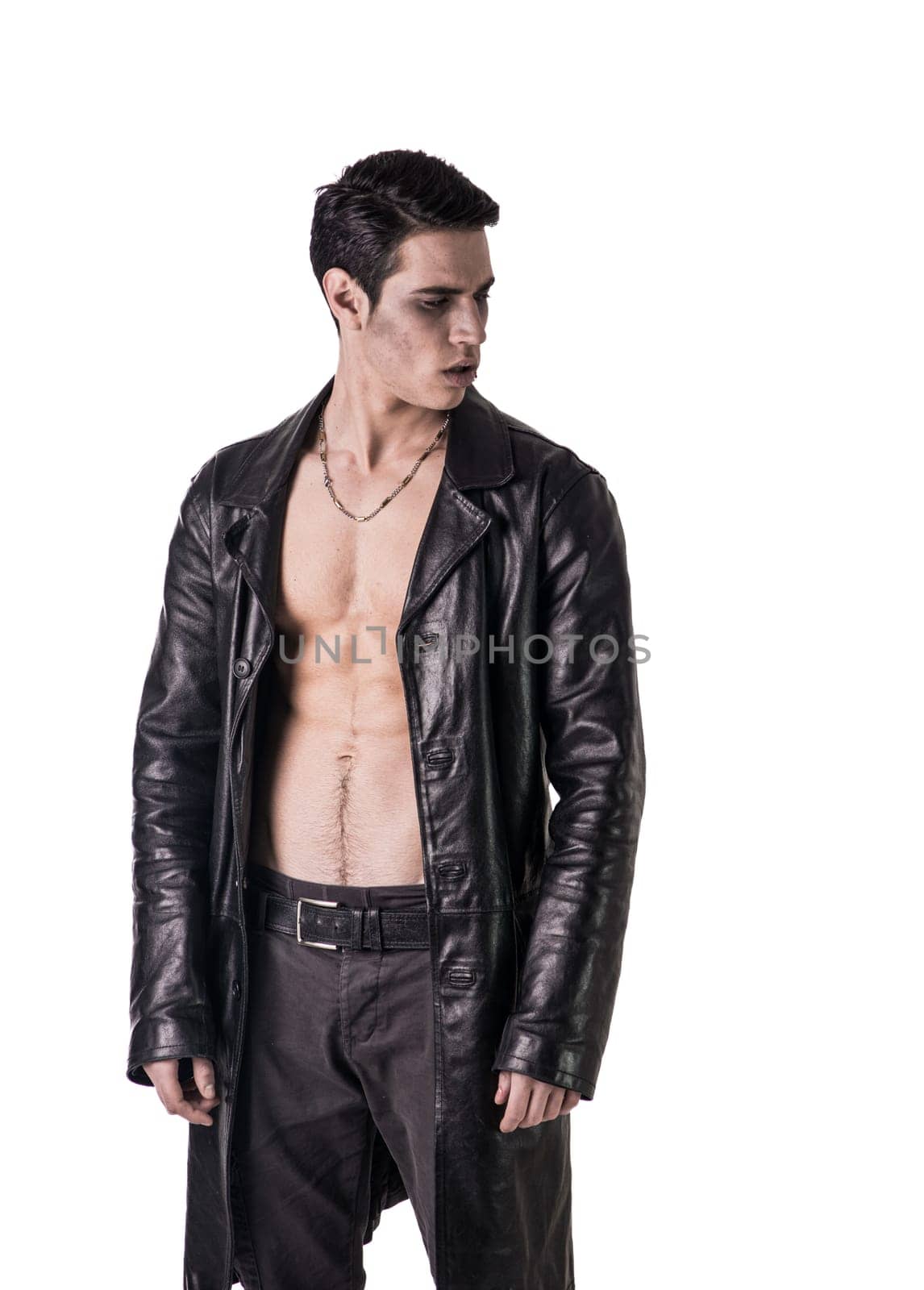 A shirtless man in a black leather jacket in a vampire look. Photo of a young and handsome vampire in a stylish black leather jacket