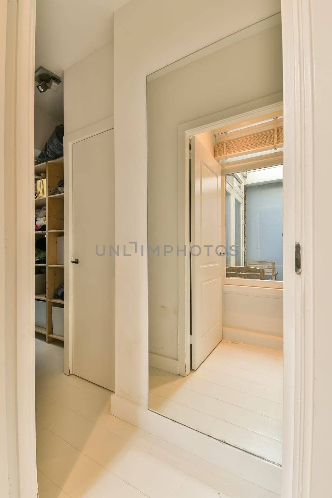 a view into a bathroom from a hallway with a by casamedia