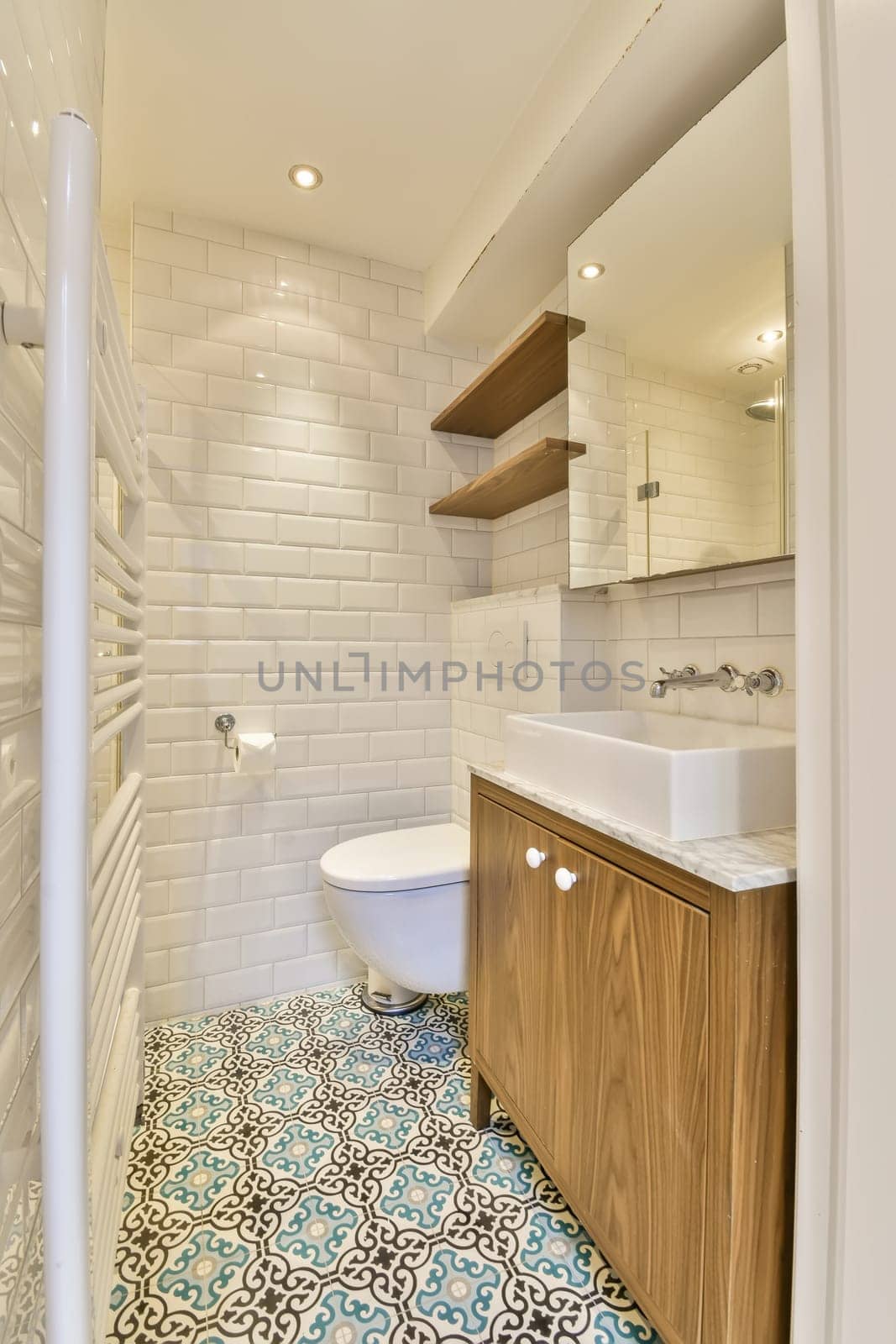 a bathroom with blue and white tiles on the floor, along with a toilet in the wall is made out of wood