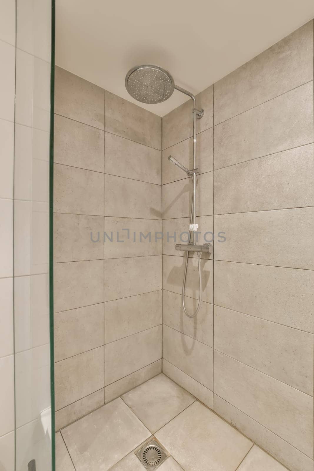 a bathroom with a shower and a glass door by casamedia