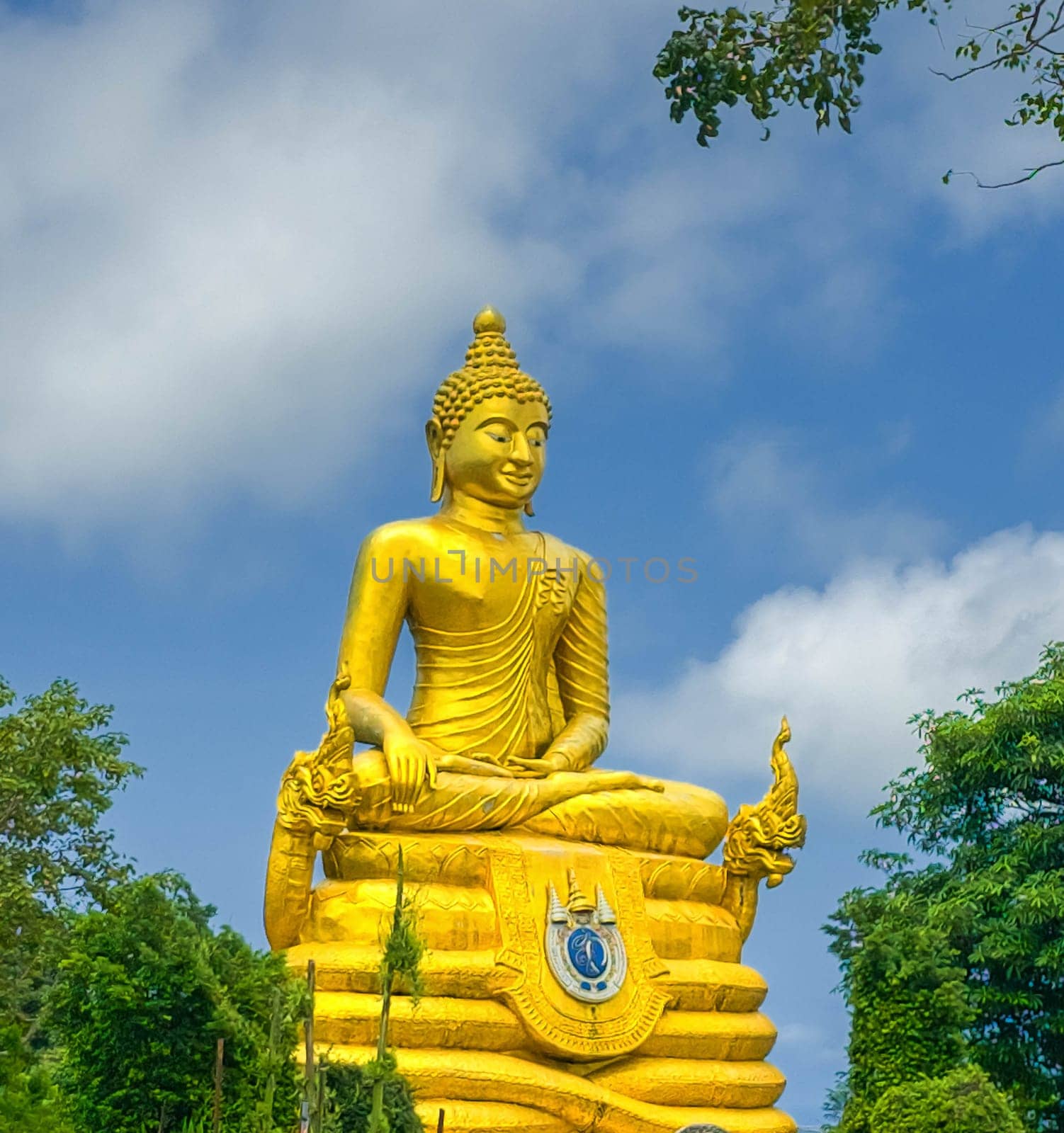 Golden Buddha statue next to statue of Big Buddha in Phuket, Thailand by Elenaphotos21