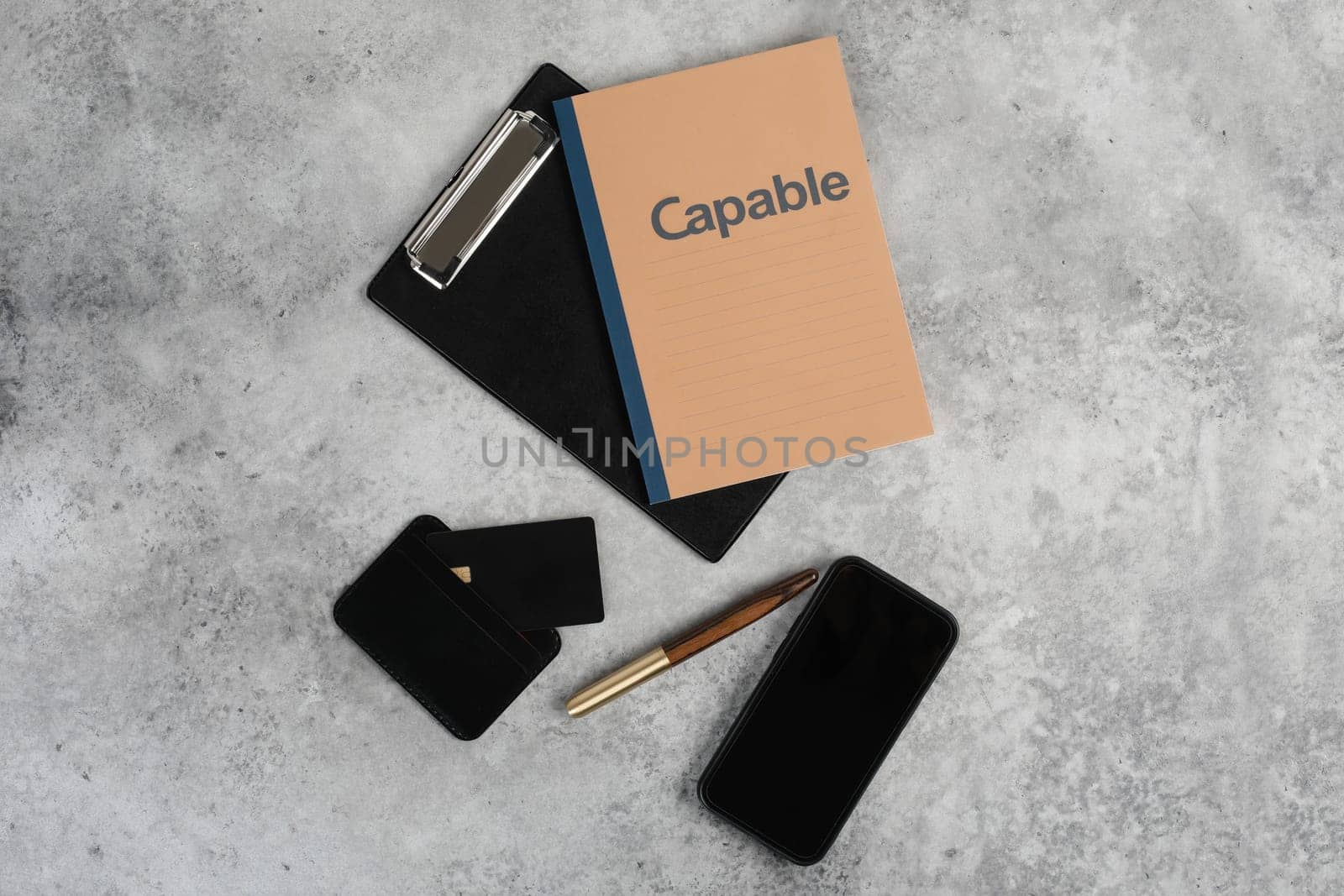 Flatlay of blank screen mobile phone, pen, creadit card, notepad on neutral grey background. Aesthetic home office desk workspace. business, work, blog template with mockup space. Flat lay, top view