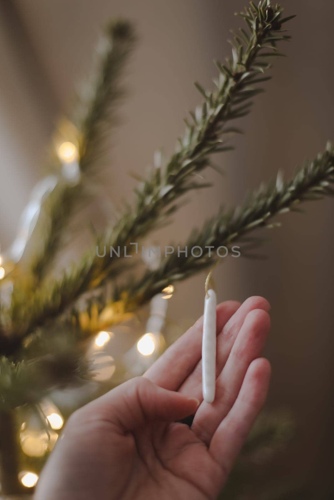 Decorating Christmas tree, holding Christmas toy in a hand. Holiday, Christmas and New Year family celebration concept. High quality photo