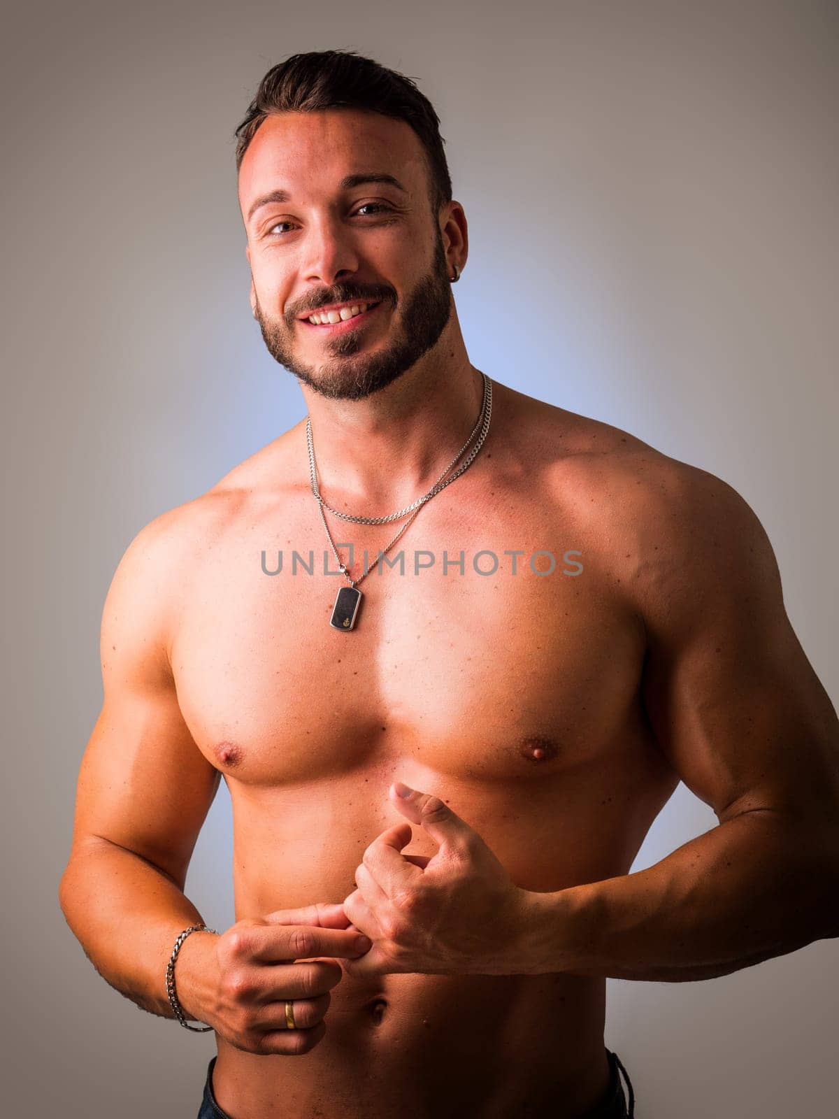 Photo of a muscular man striking a pose for a captivating portrait by artofphoto