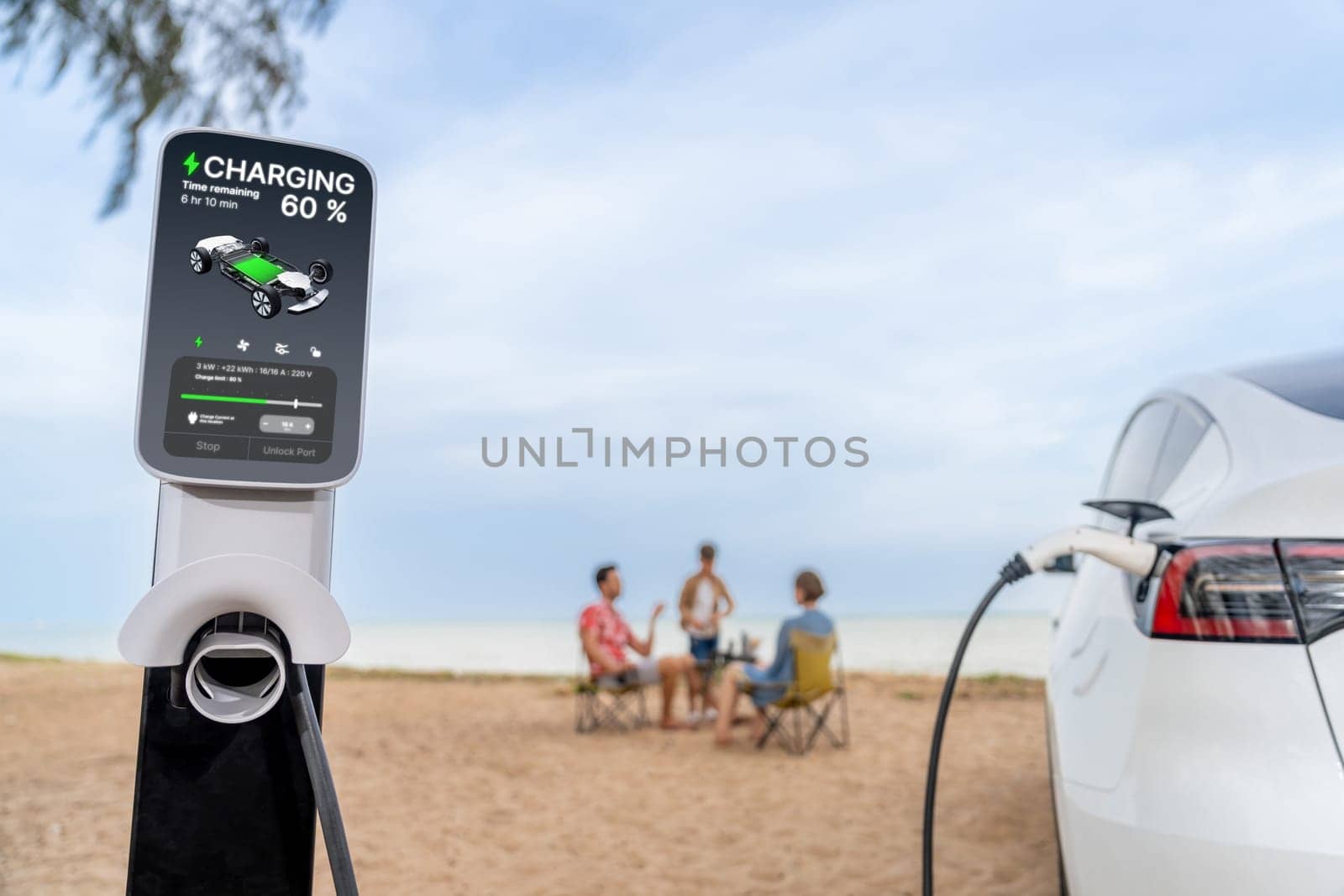 Alternative family vacation trip traveling by the beach with electric car recharging battery from EV charging station with blurred family enjoying the seascape background. Perpetual