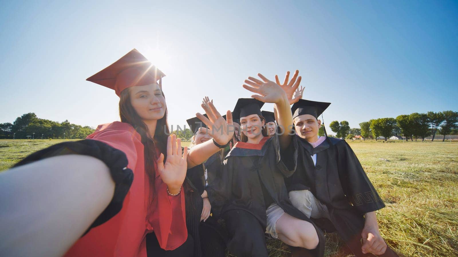 College alumni take selfies in the meadow