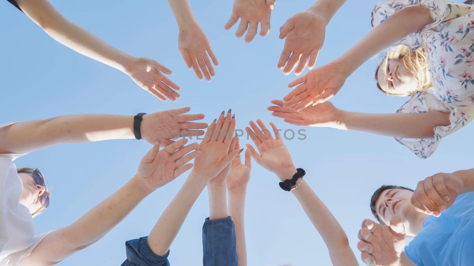 Seven boys and girls join hands as a sign of strong friendship