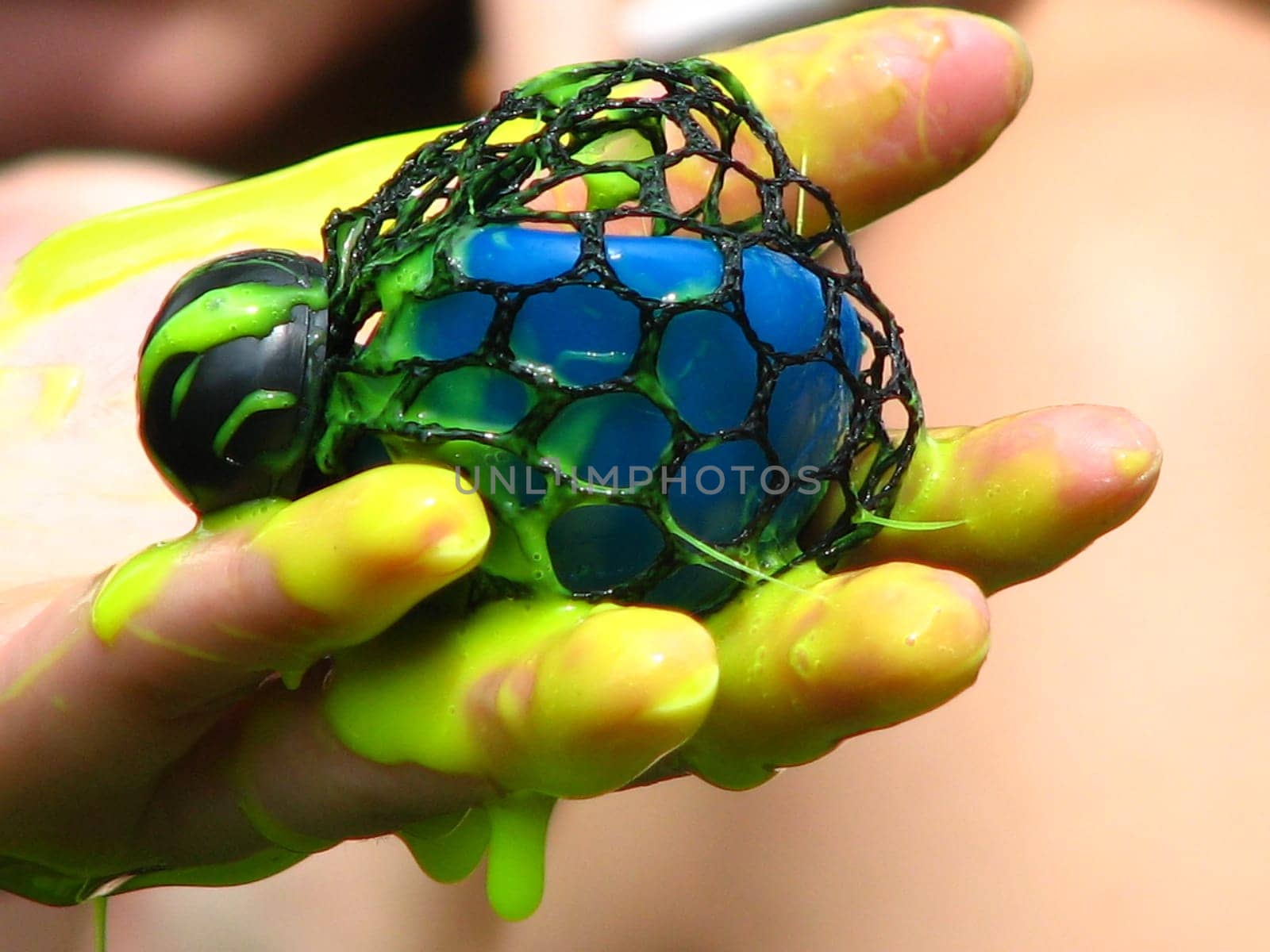 I can't say exactly what the toy is called. It is a kind of rubber ball filled with a somewhat viscous rubber mass (slimy). And usually throws yellow bubbles when you press it. In this case,the friend had pressed a little too hard,and was