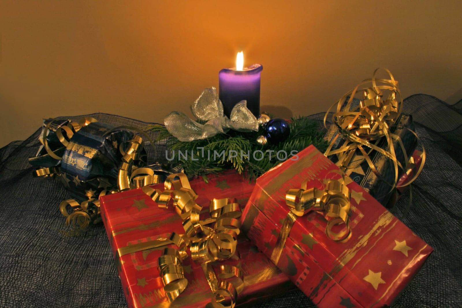 Christmas arrangement with candle and gifts