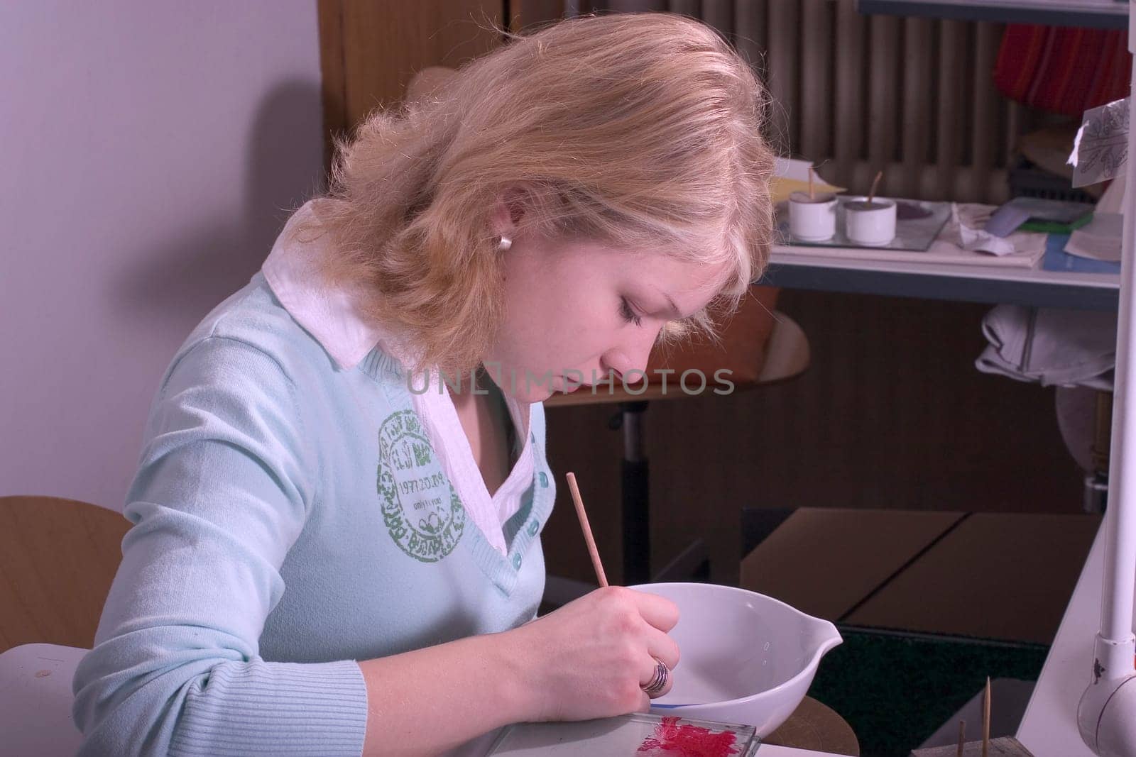 College-teacher painting a porcelain bowl