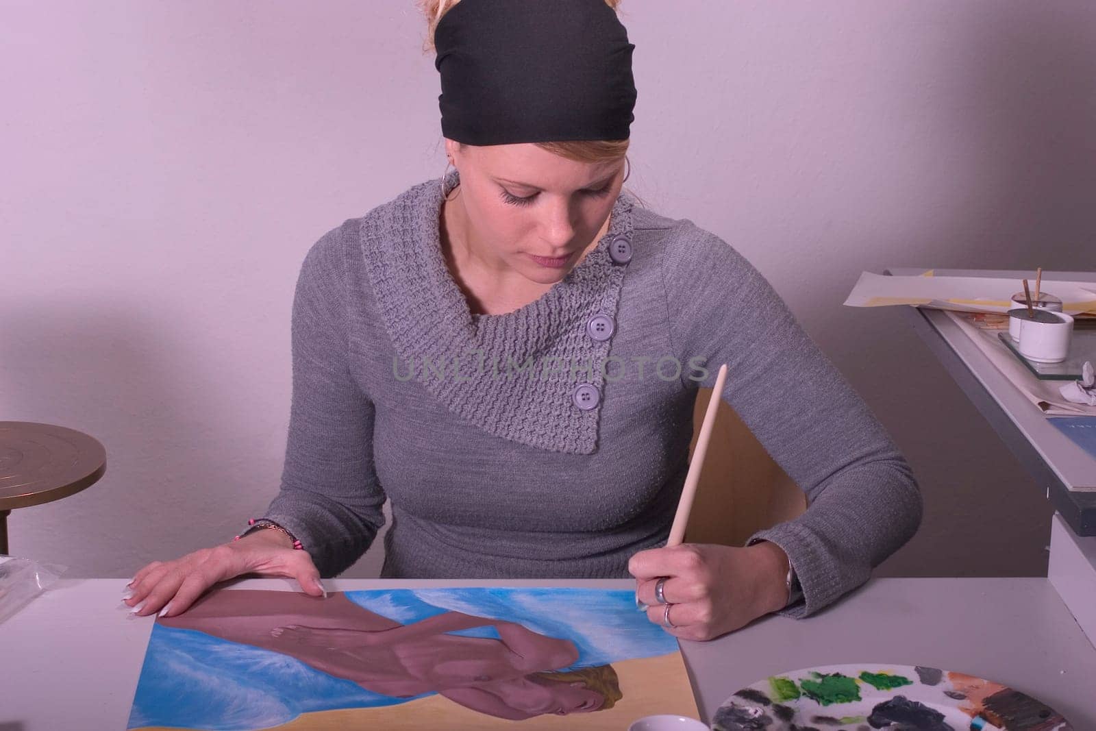 High school student painting a female nude