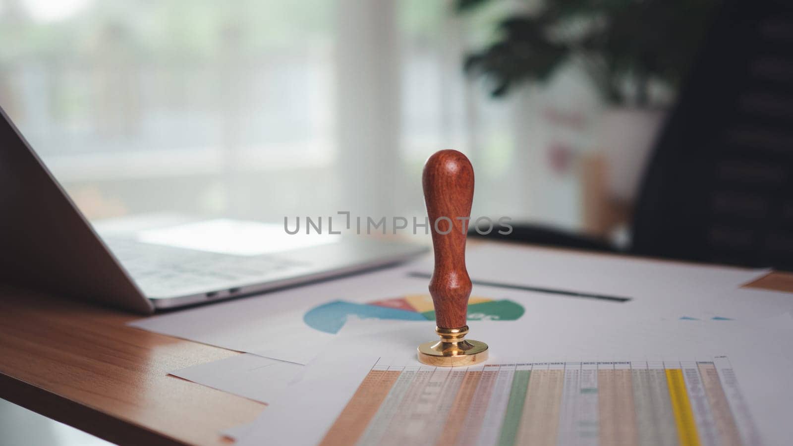 The company seal was placed on the desk. Stamping to document approve and reject project, Signing a business contract approval of contract documents confirmation, approval stamp, copy space. by Unimages2527