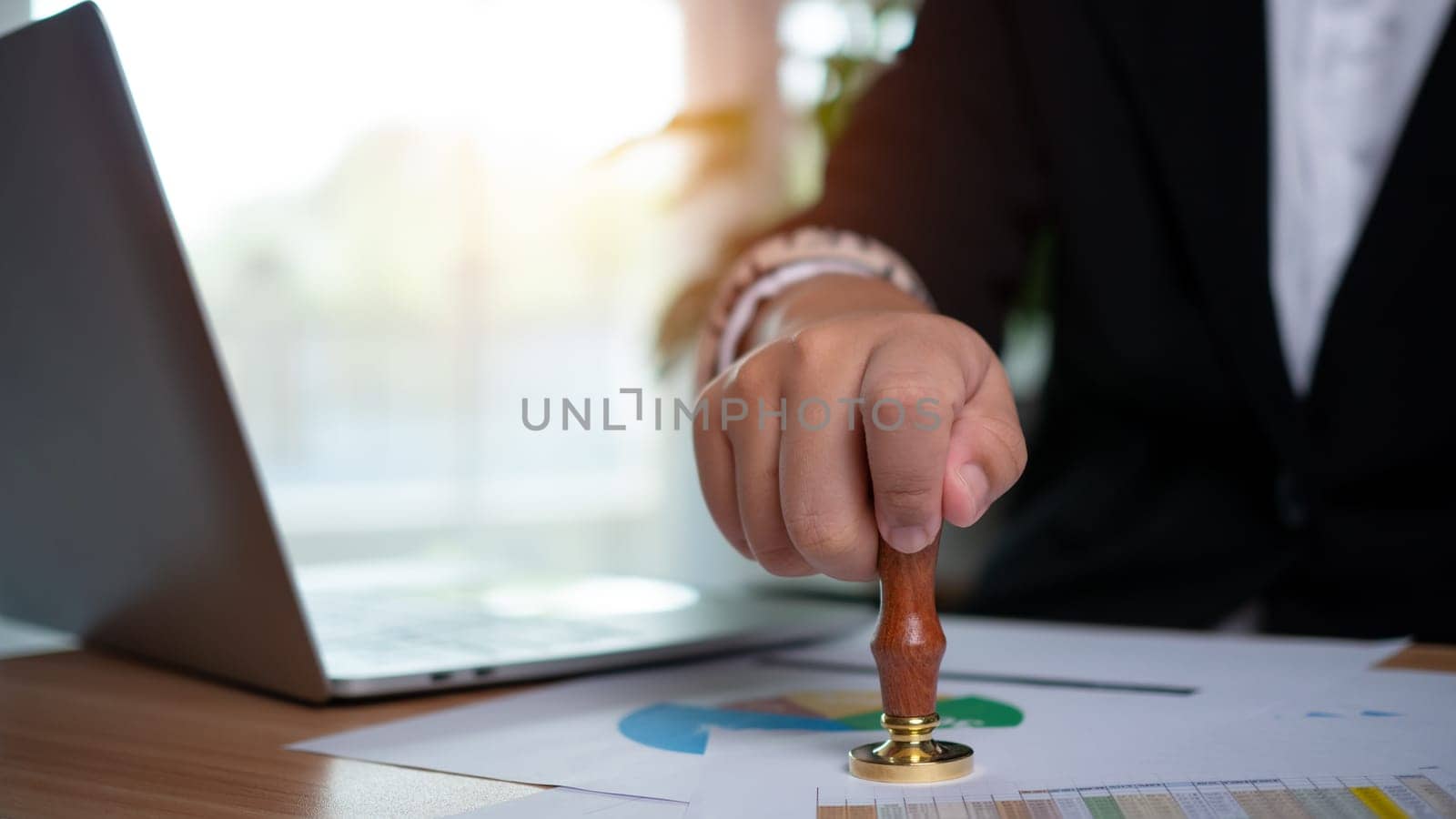 Businessman hand using wooden stamping to document approve and reject document or project, Signing a business contract approval of contract documents confirmation, approval stamp, copy space.