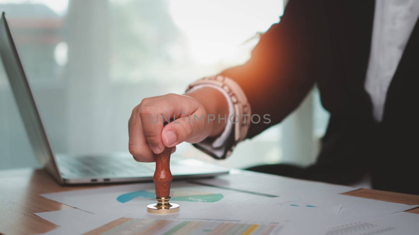 Businessman hand using wooden stamping to document approve and reject document or project, Signing a business contract approval of contract documents confirmation, approval stamp, copy space. by Unimages2527