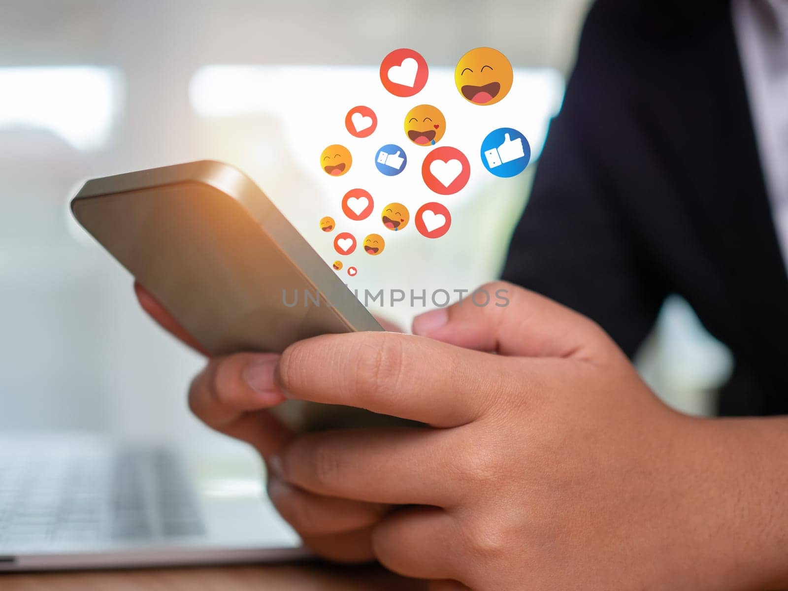 Social media and technology concepts , Human hand is holding a phone and there is a social media icon. by Unimages2527