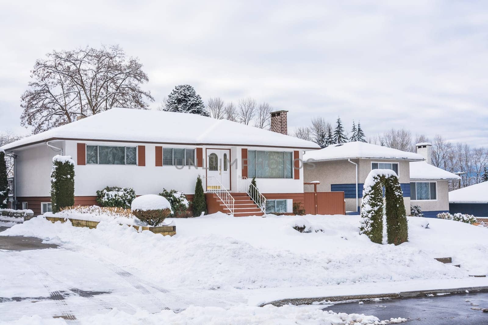 Street of residential houses in suburban of Vancouver on winter cloudy day by Imagenet