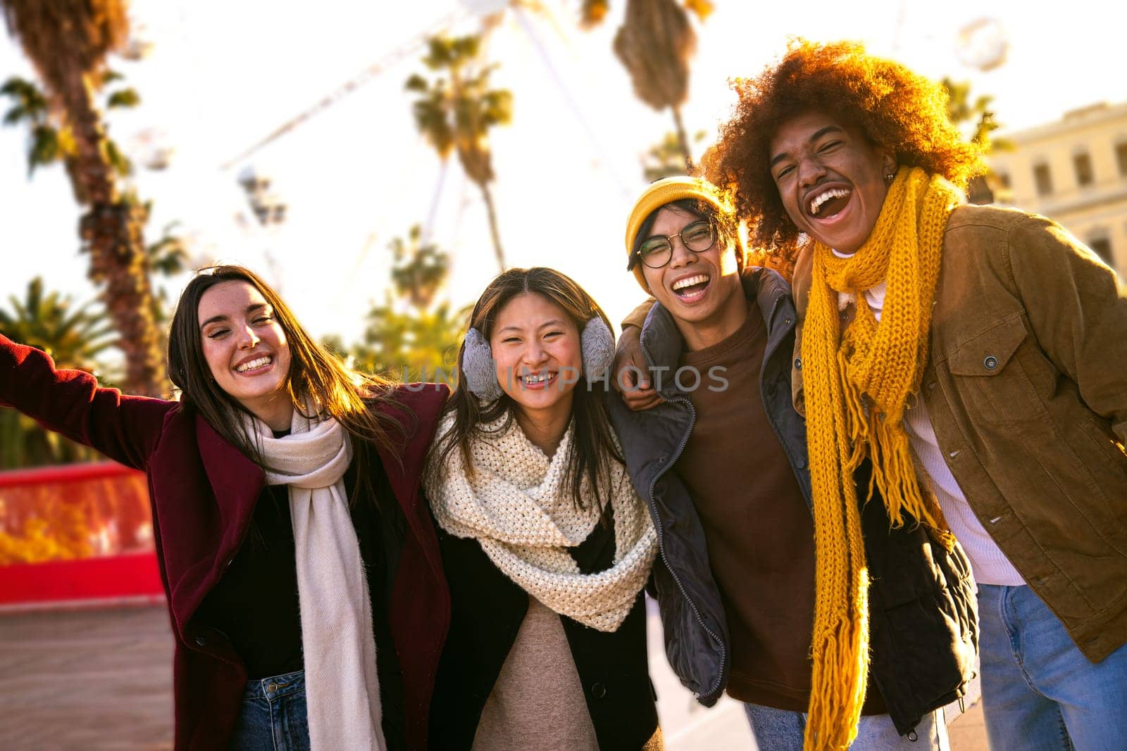 Happy multiethnic diverse group of friends looking at camera smiling on a sunny winter day outdoors.Lifestyle portrait concept.