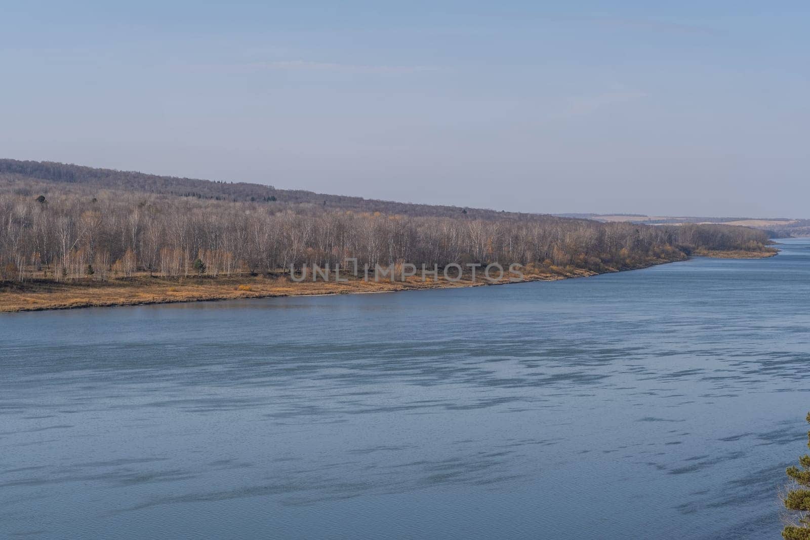 Beautiful, wide autumn river among forests and rocky shore. by AnatoliiFoto