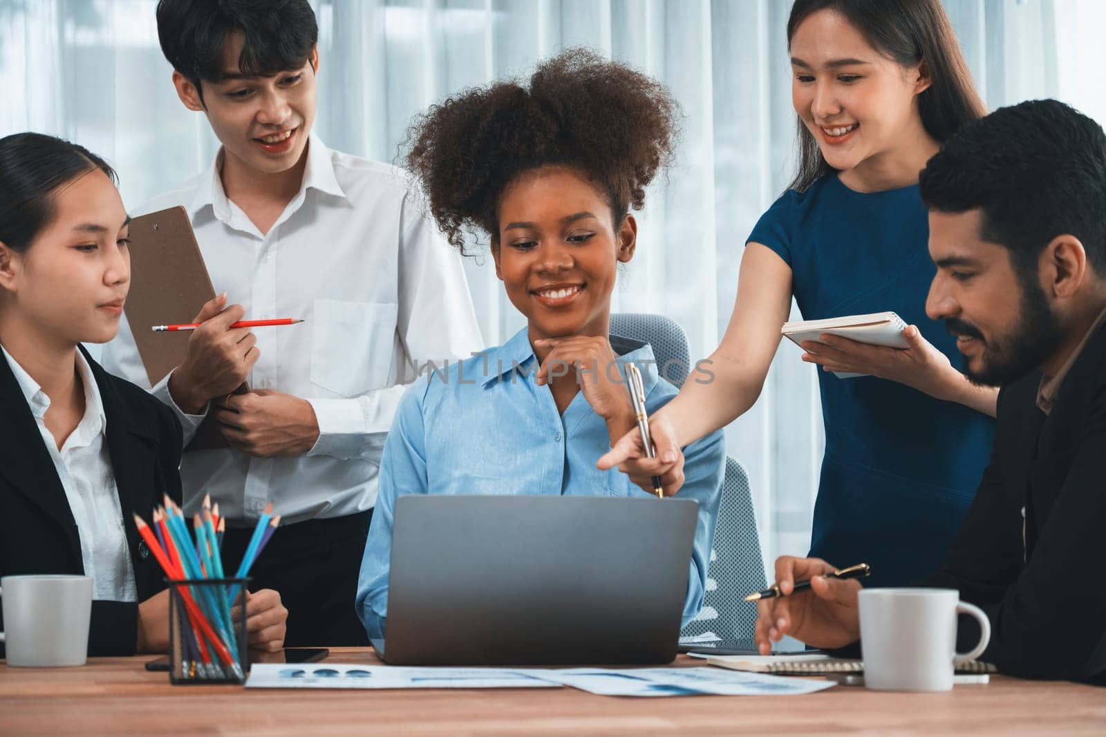 Happy diverse business people work together, discussing in corporate office. Professional and diversity teamwork discuss business plan on desk with laptop. Modern multicultural office worker. Concord