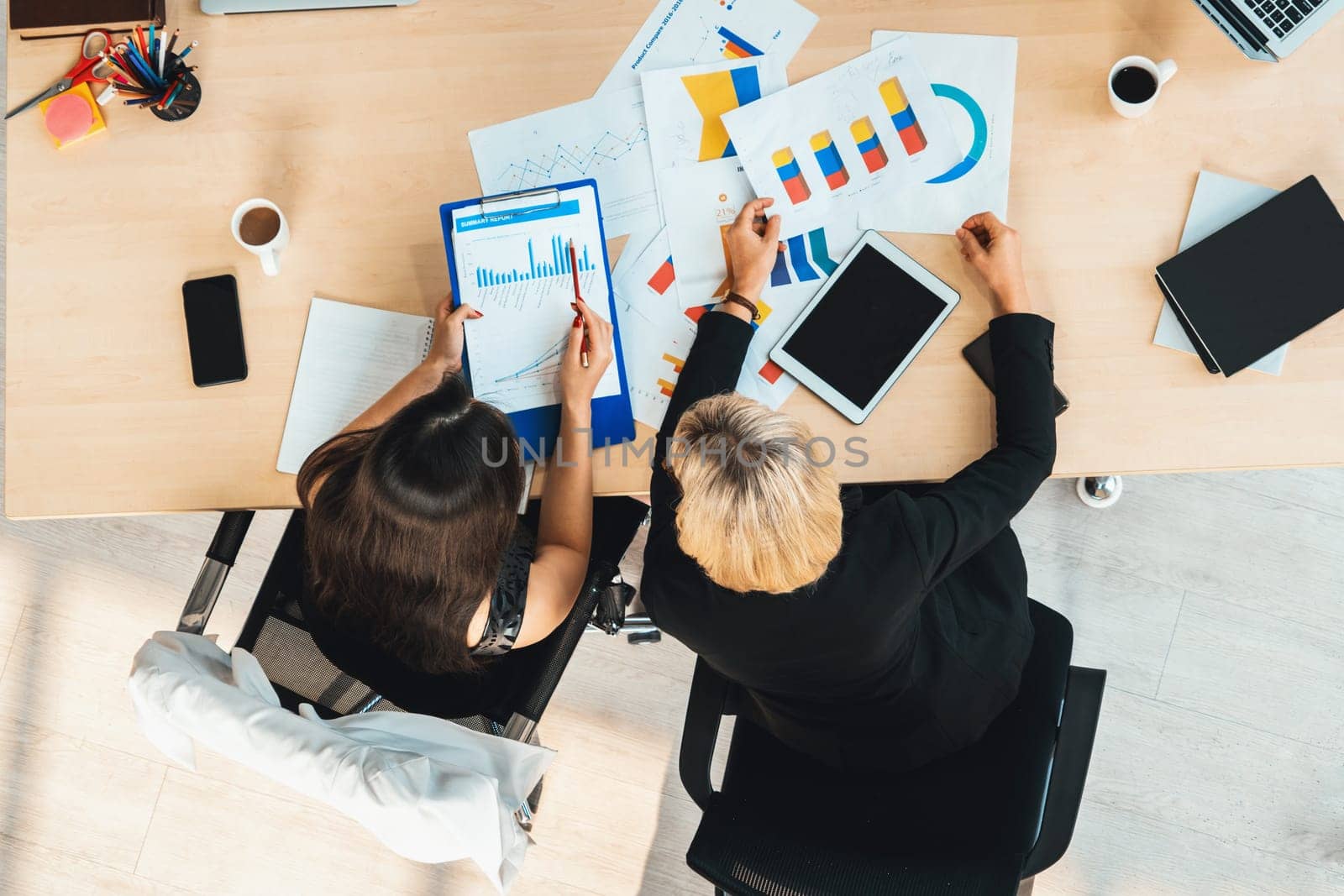 Business people group meeting shot from top view in office . Profession businesswomen, businessmen and office workers working in team conference with project planning document on meeting table . Jivy