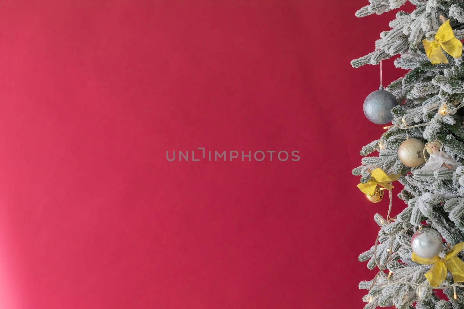 Christmas composition. Christmas red decorations, fir tree branches on red background. Flat lay, top view, copy space