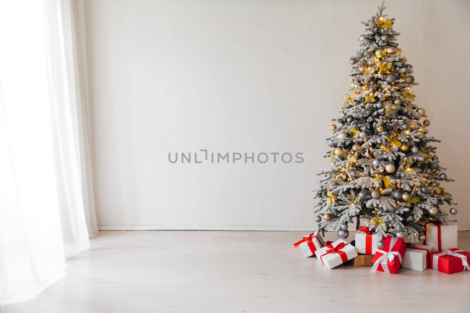 christmas tree with gifts, lights, garlands, toys for new year by Simakov