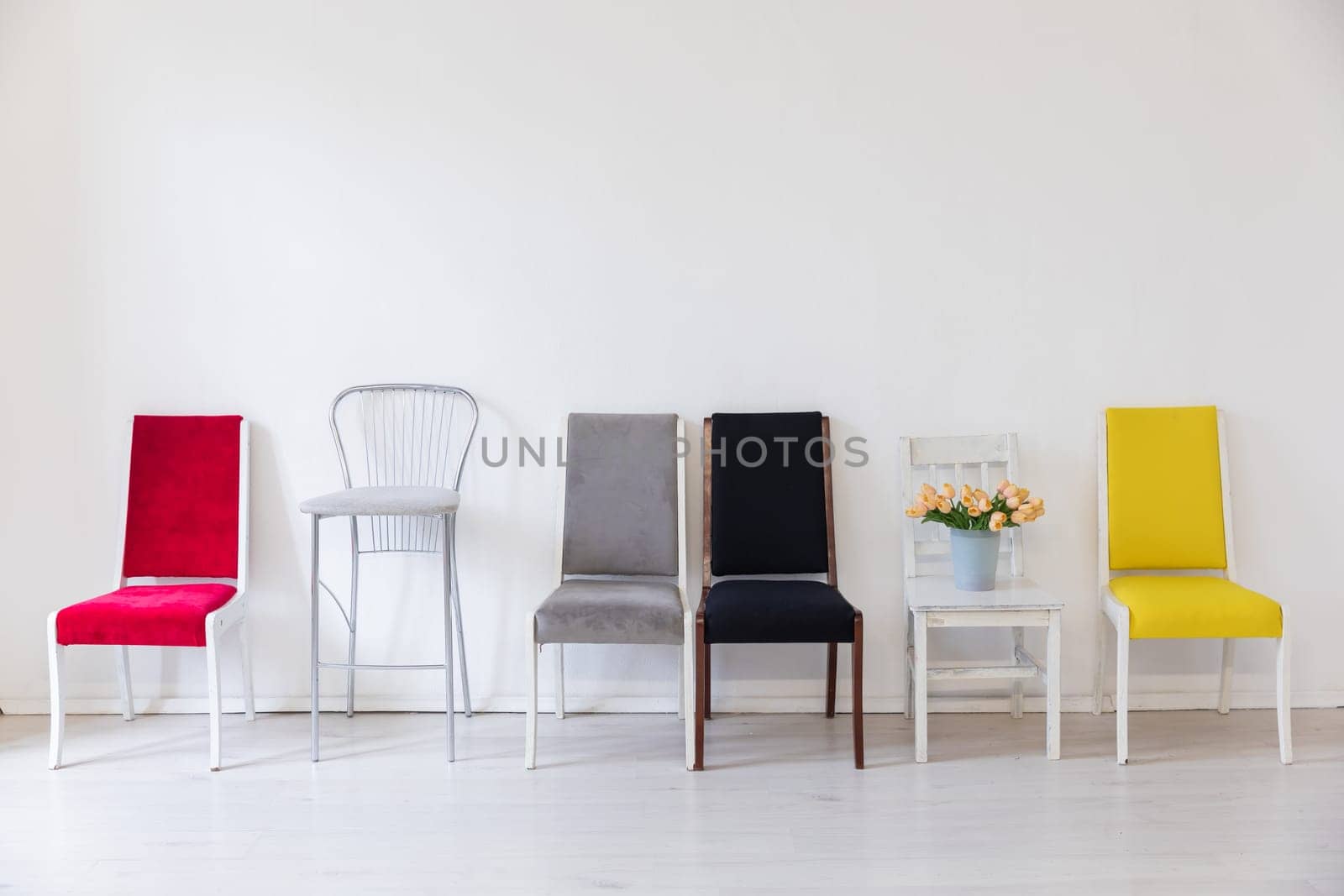 Lots of different chairs in the interior of a white room by Simakov