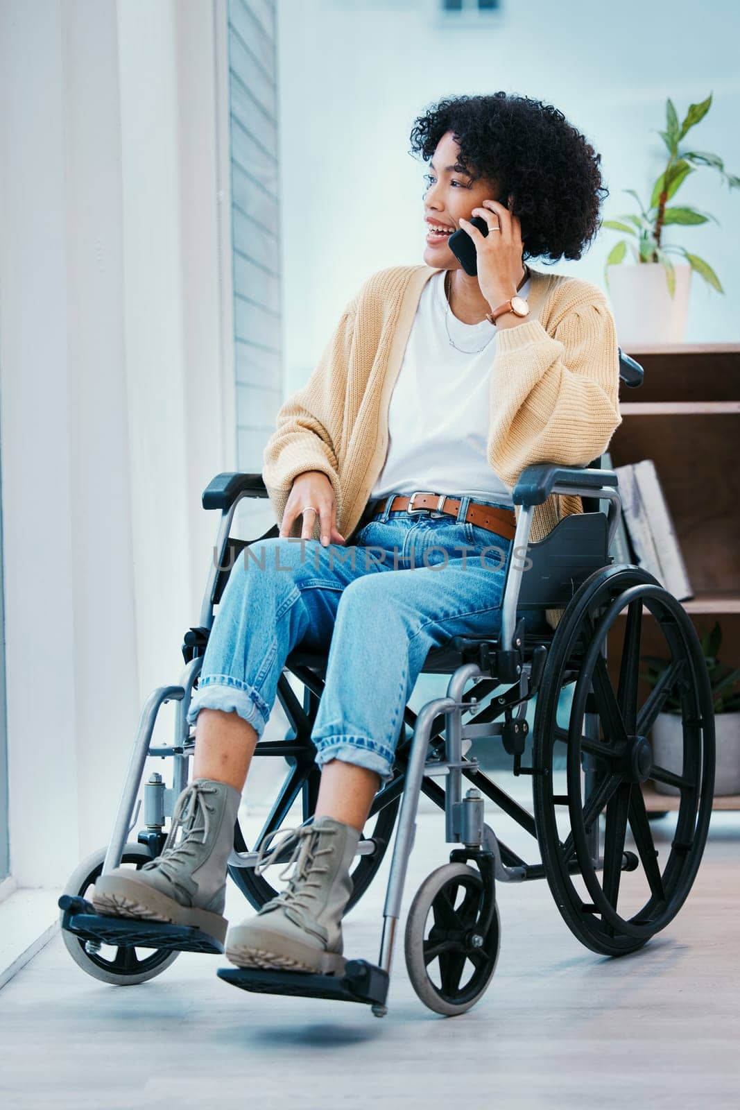 Phone call, wheelchair and happy woman talking in home, chat and speaking. Mobile, conversation and smile of person with a disability, online communication and smartphone technology for discussion.
