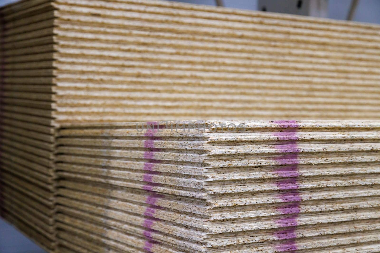 stacks of tongue and groove water resistant OSB compressed sawdust sheets.
