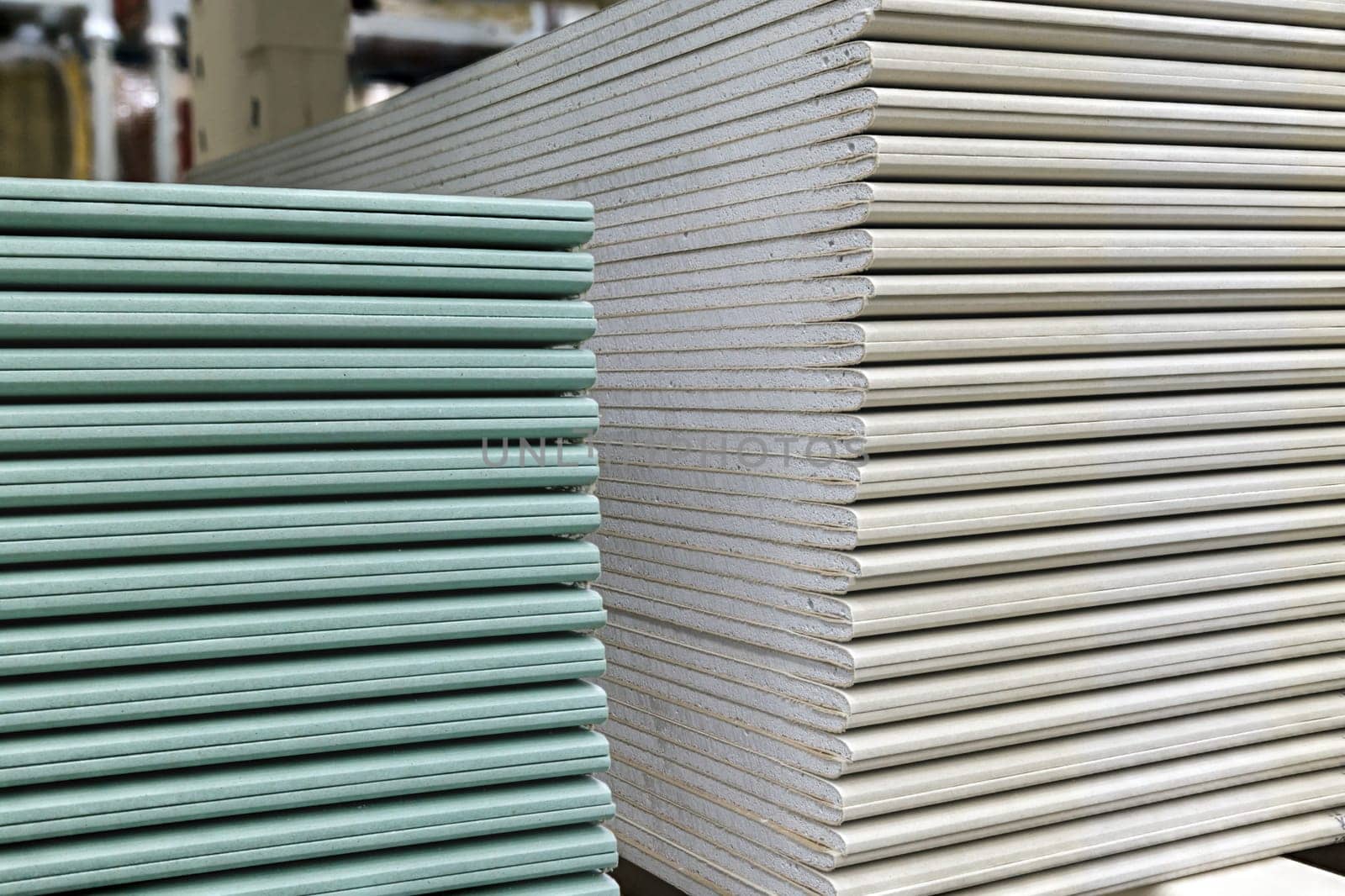 Drywall sheets stacks. Plasterboard sheets are stacked on top of each other. Construction and repair material. Closeup view.