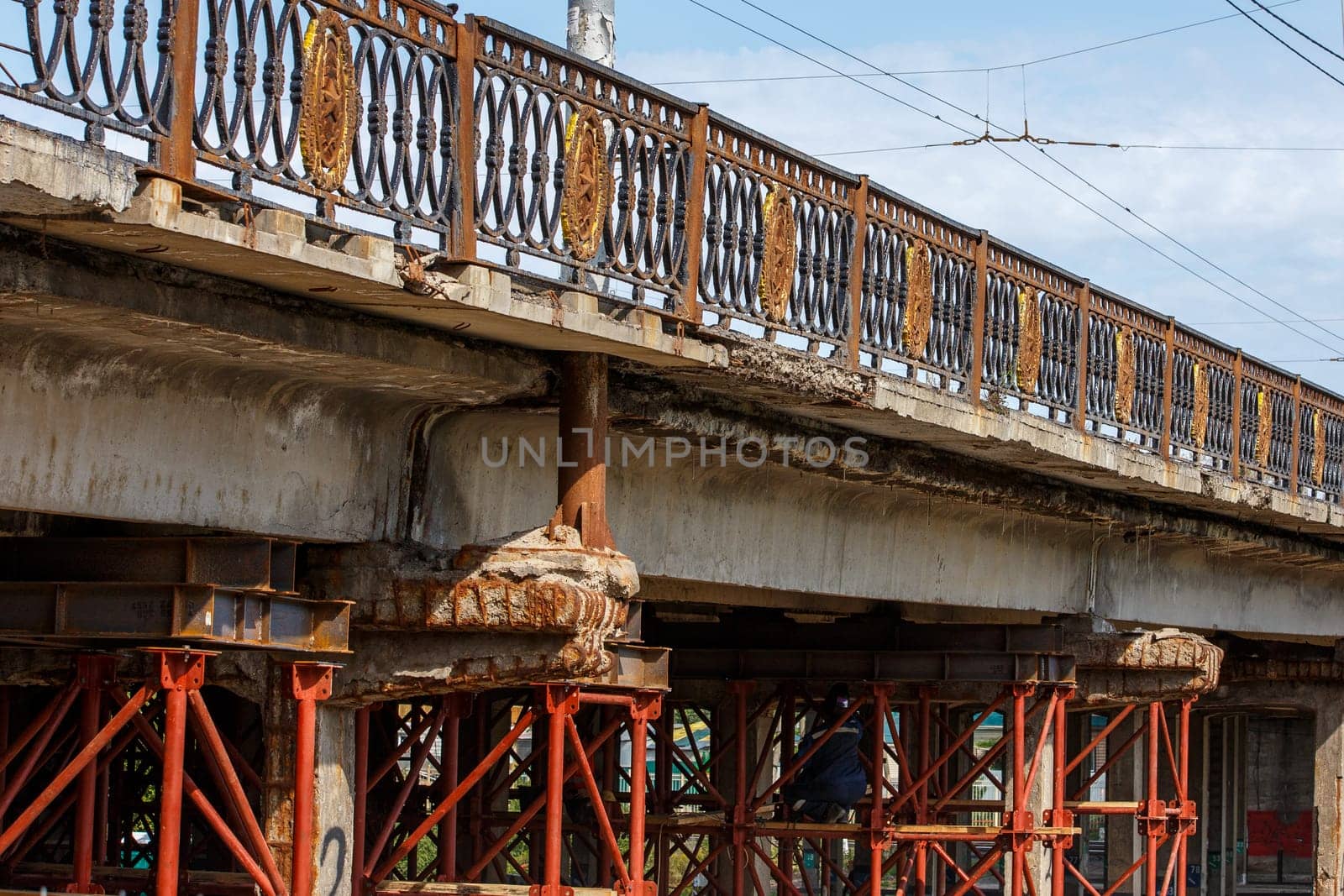 old soviet automotive bridge repair process with red scaffolds and supporting constructions.
