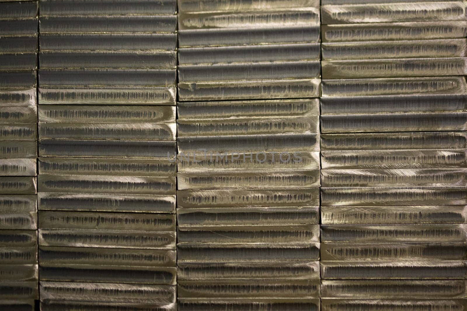 stack of laser cut steel billets - closeup texture and background.