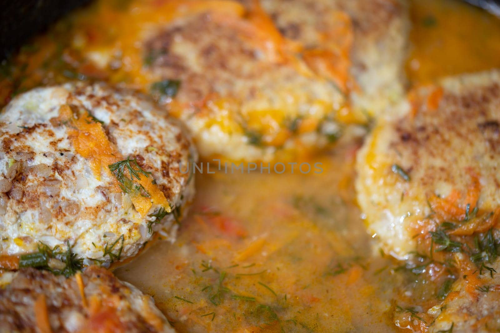 delicious chicken cutlets fried in a frying pan with gravy, unadorned real life closeup photo with selective focus