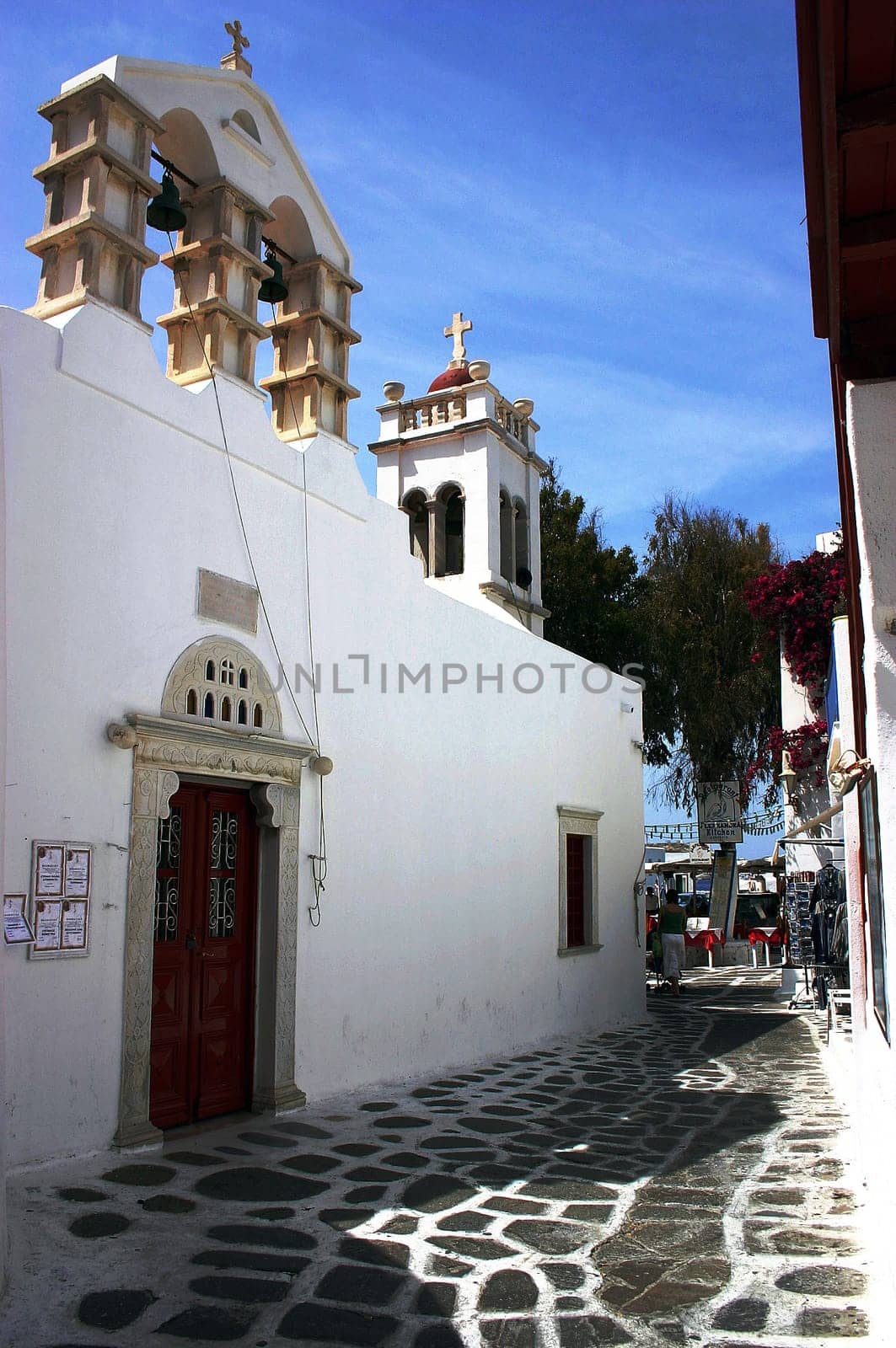An alley with a church in the old town of Mykonos.