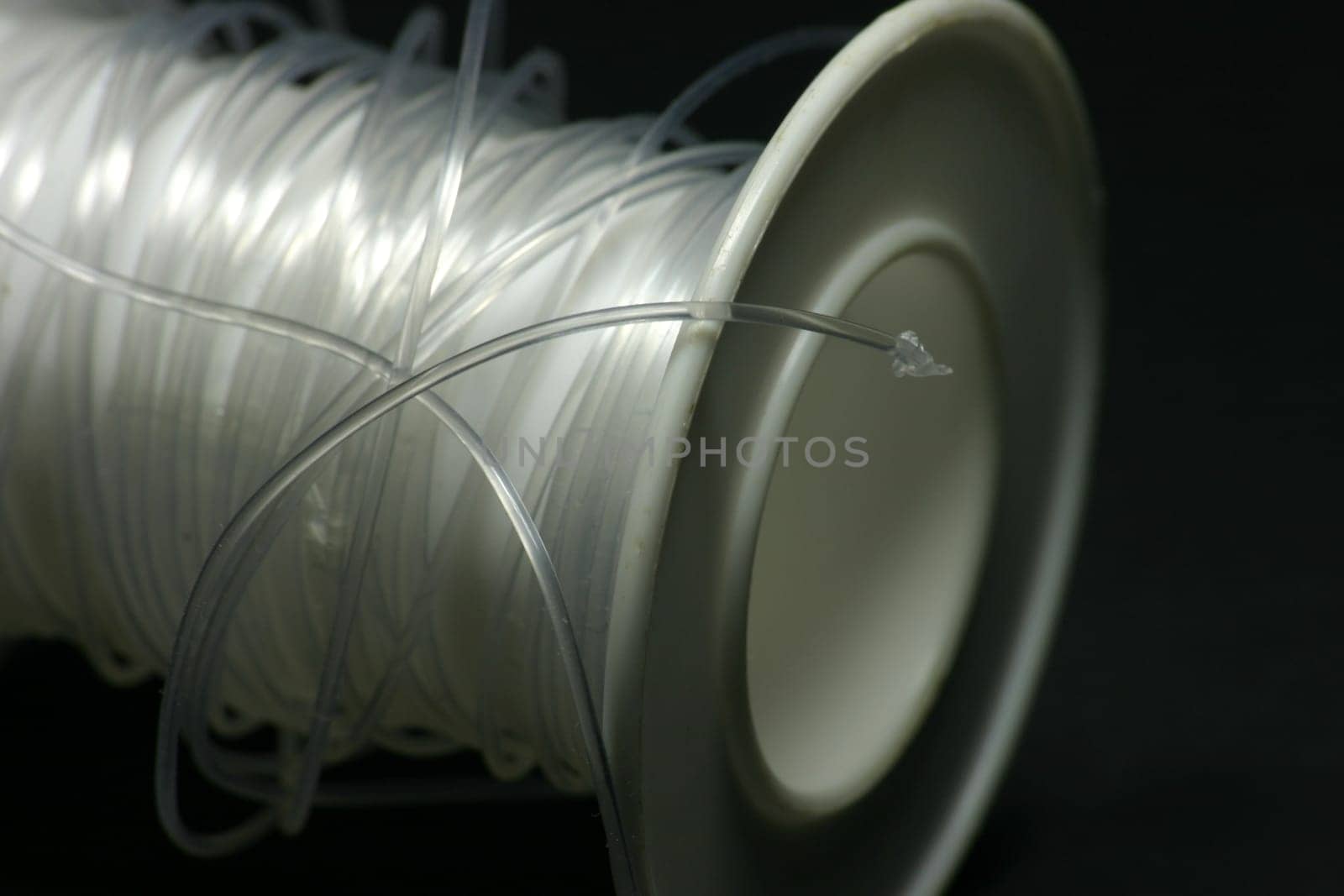 Clear thread on white plastic roll