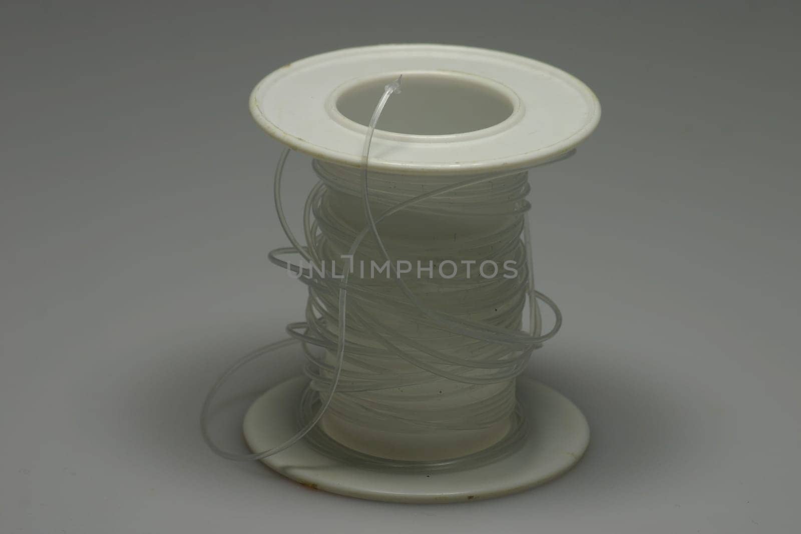 Clear thread on white plastic roll
