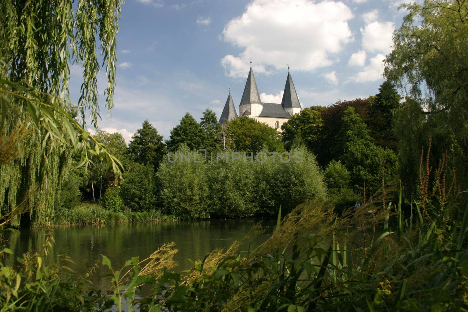 View over a lake to the imperial cathedral in Königslutter am Elm