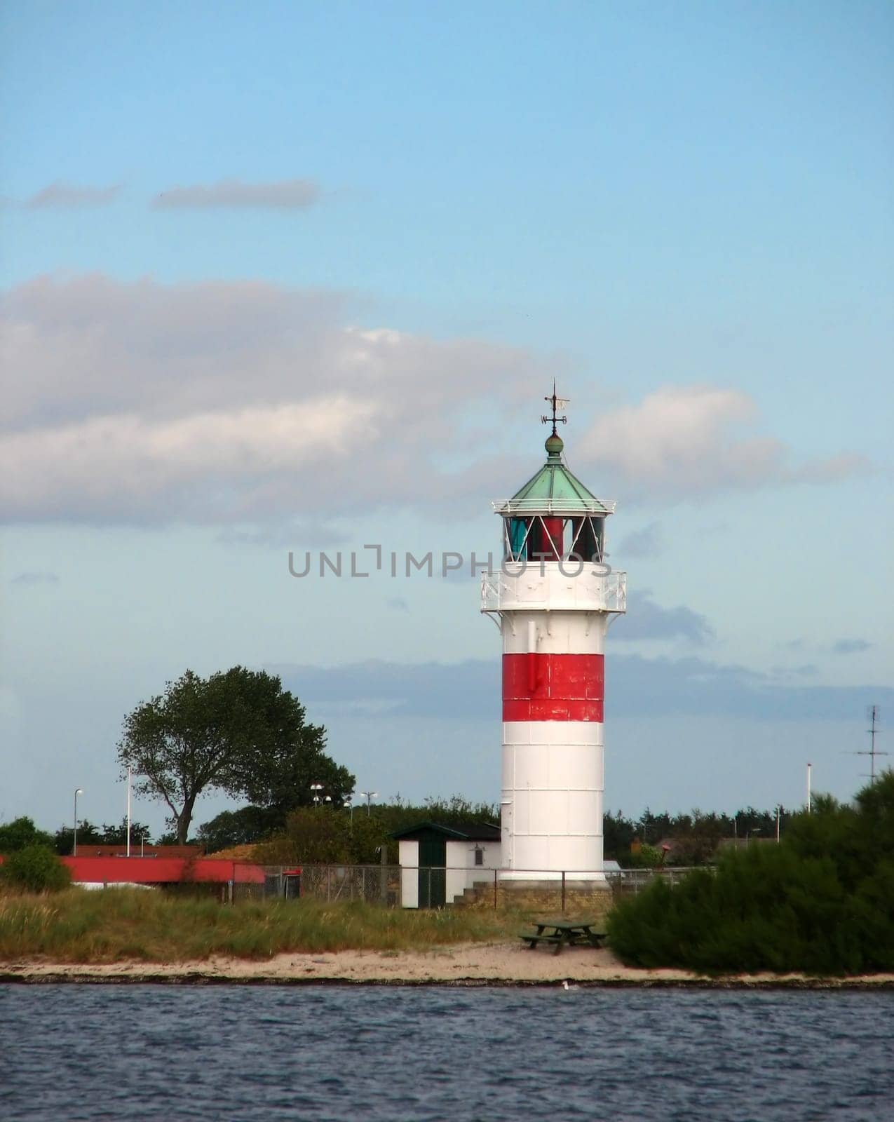 The lighthouse of the small Danish island of Årø. The island has a small harbor and a tiny village. There is a ferry service to the mainland. _/)_/)_/) Cam. Canon Power Shot S2 IS