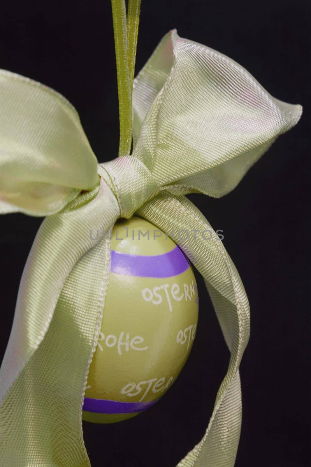 Easter egg,hanging,against a black background