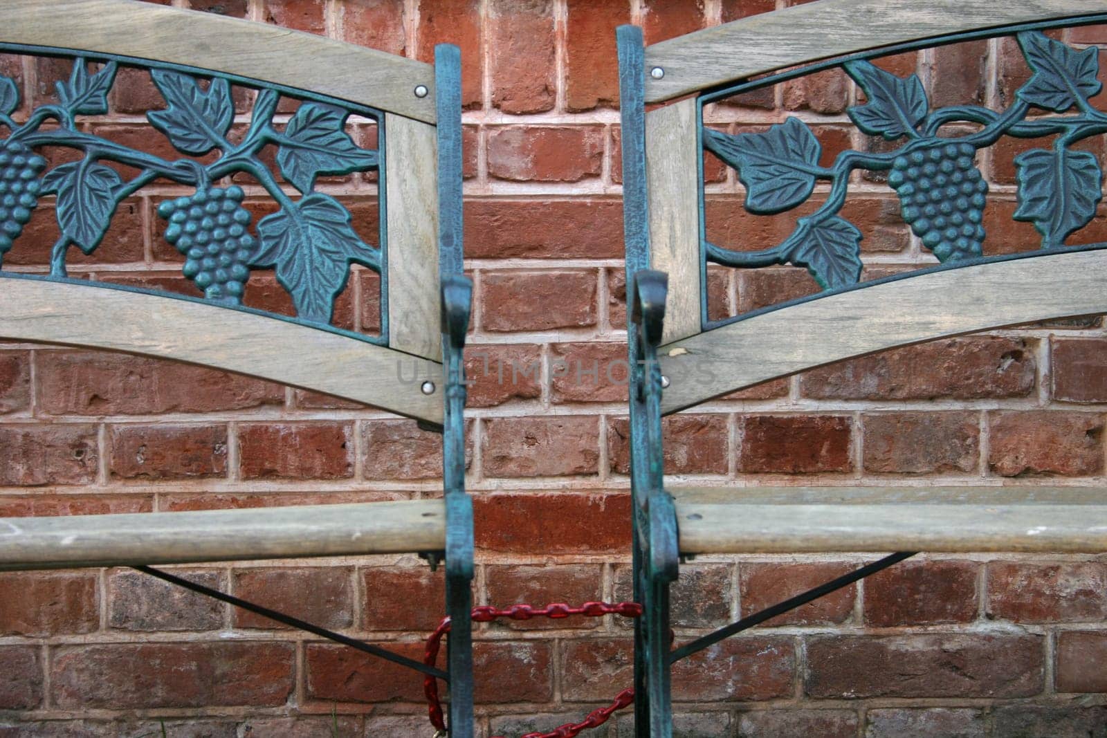 Two benches in front of a brick wall