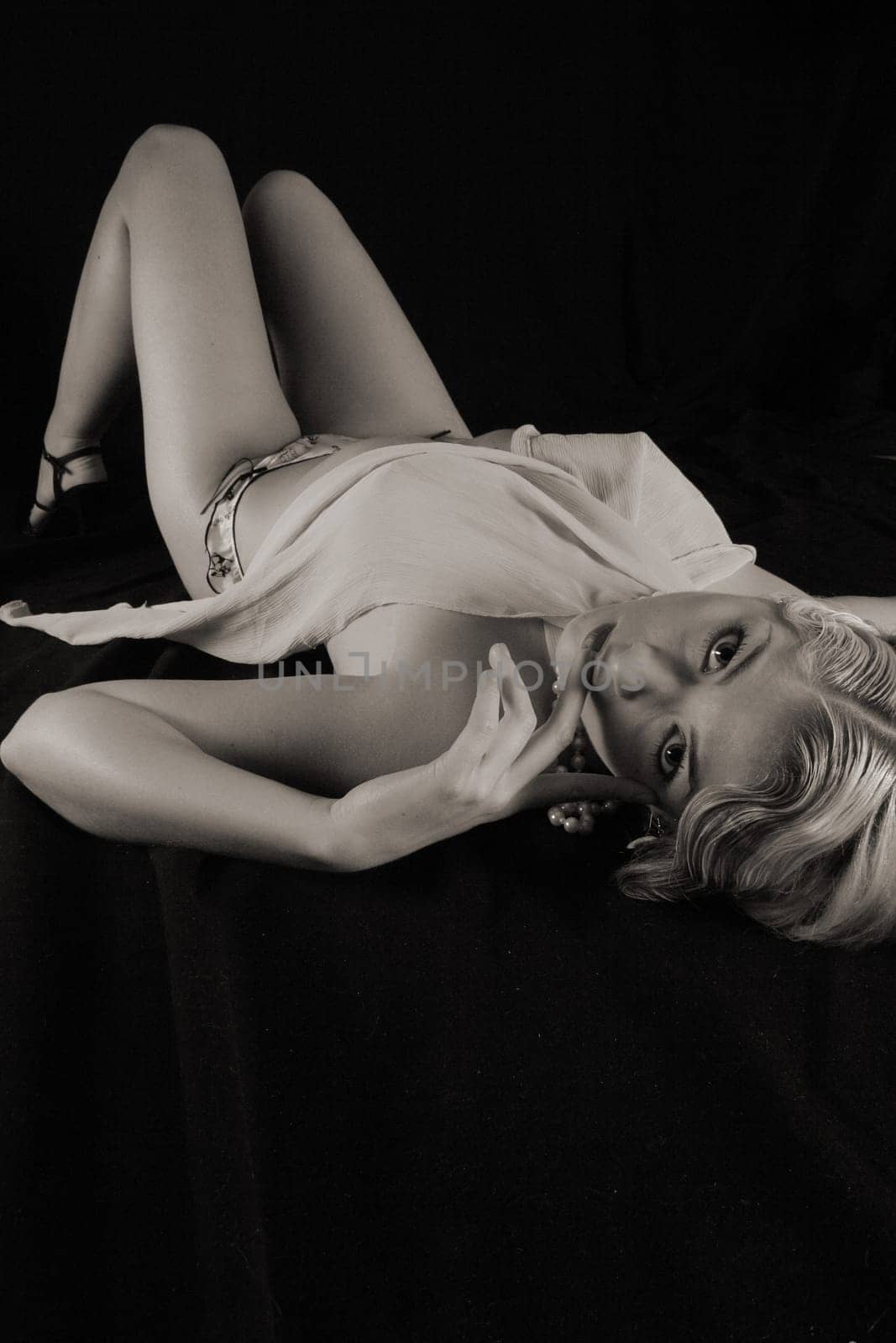 A woman lying down in the style of the 20s