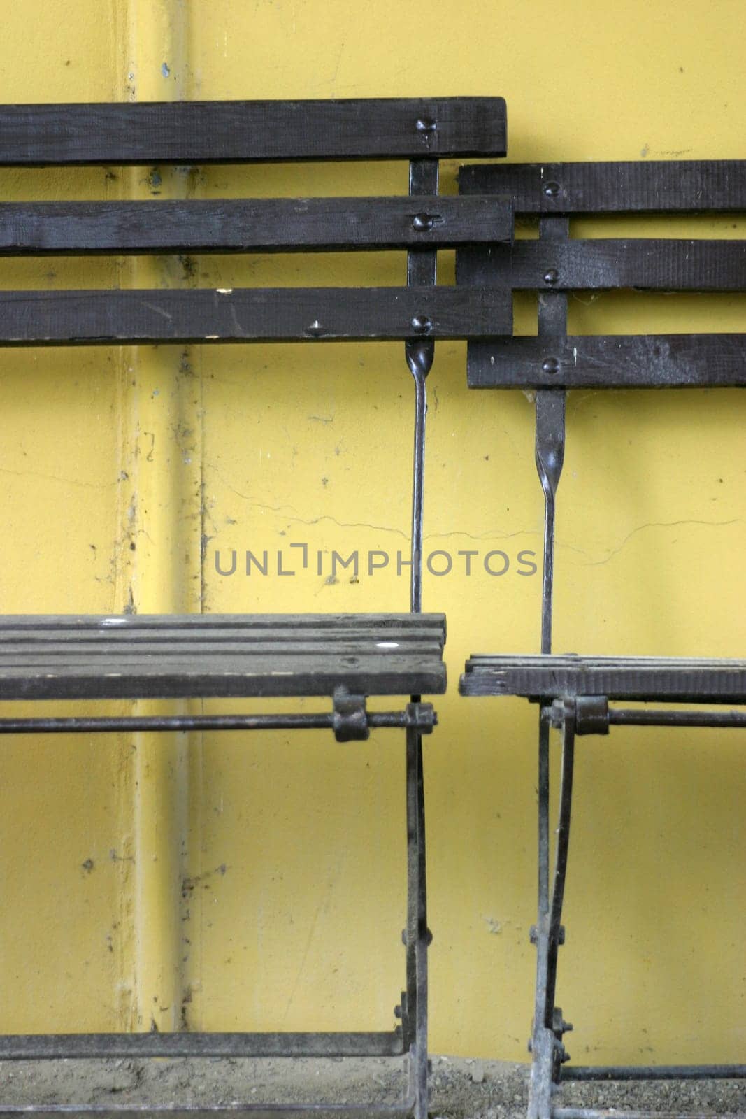 Folding chairs in front of a yellow wall