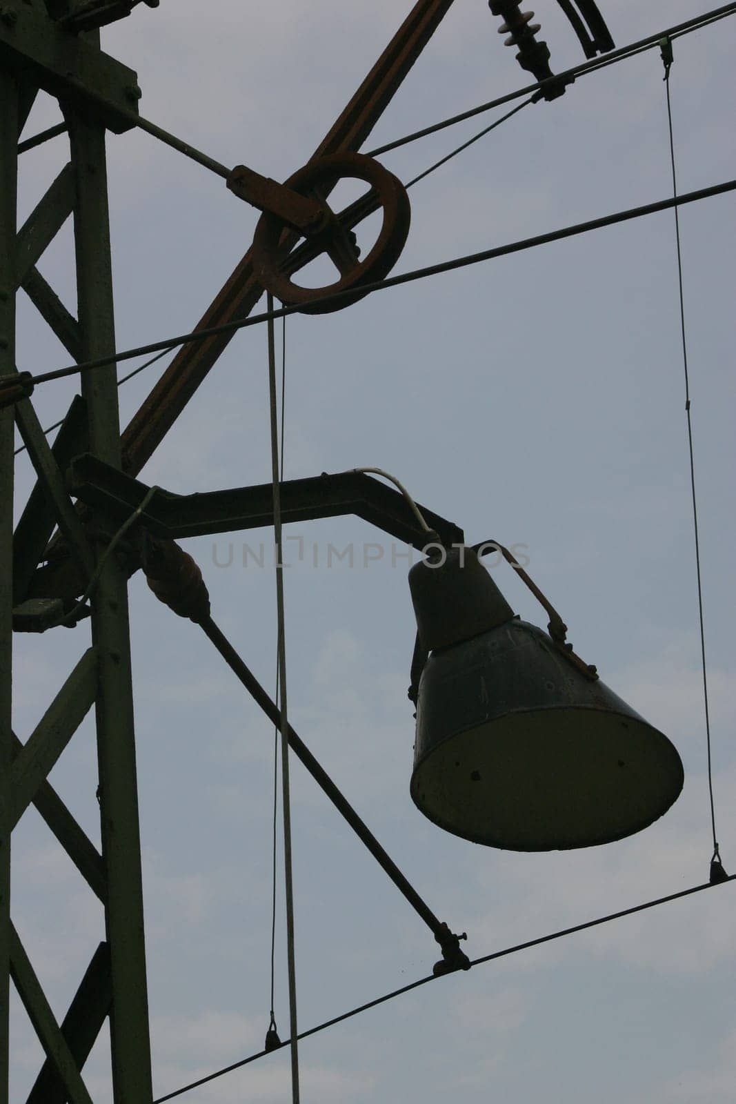 Combined power and lamppost on a railway line
