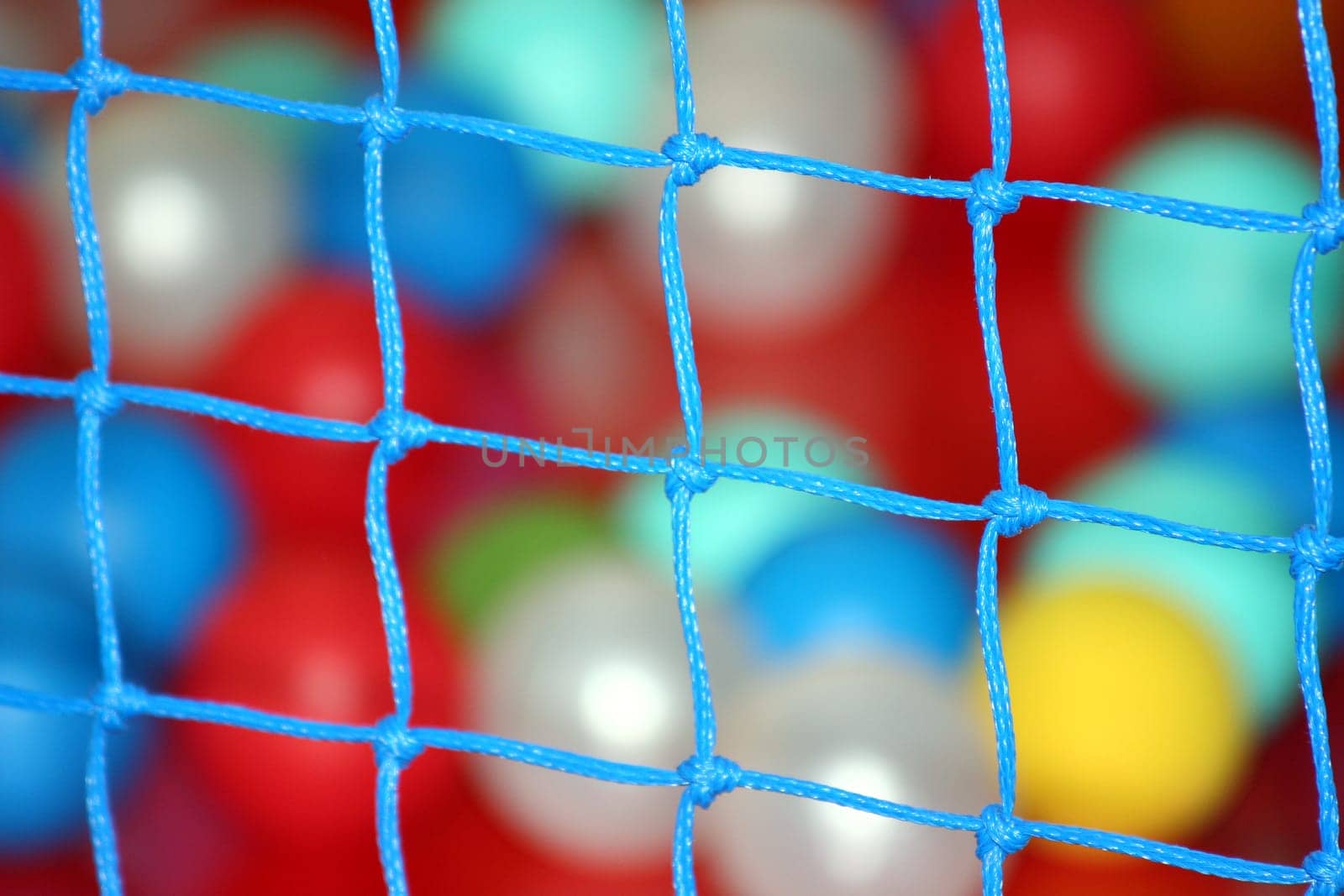 Balls behind colorful net