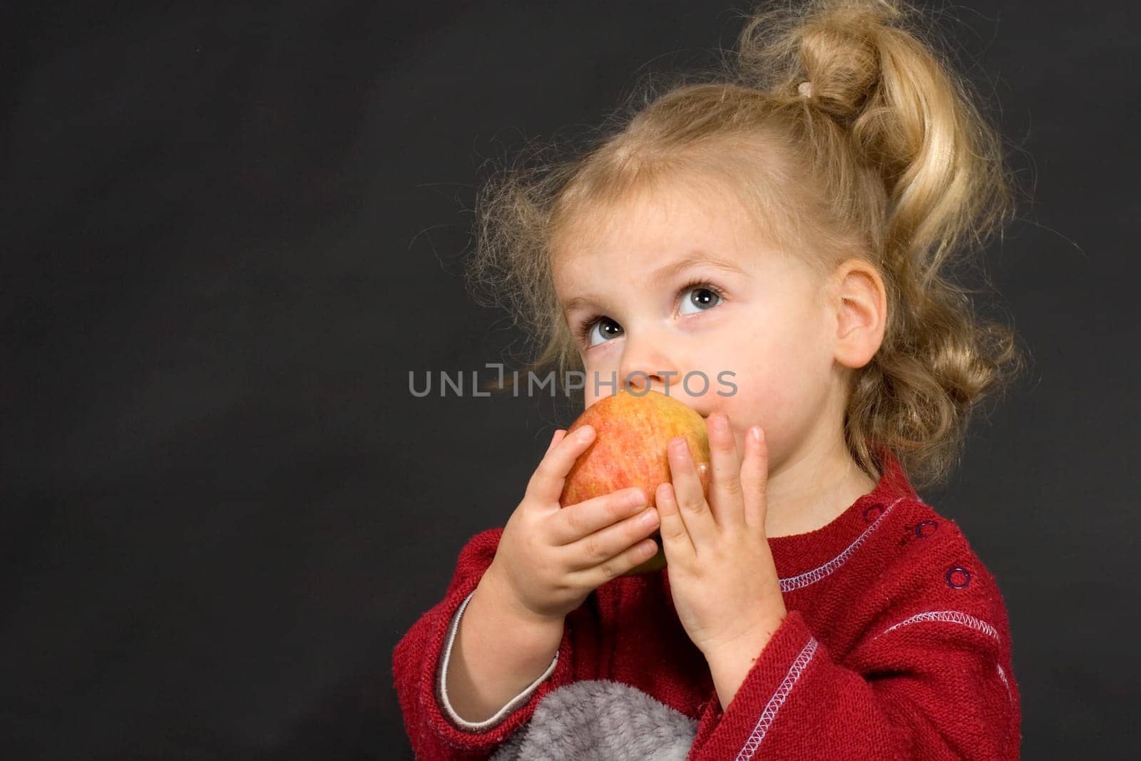 Child eats an apple
