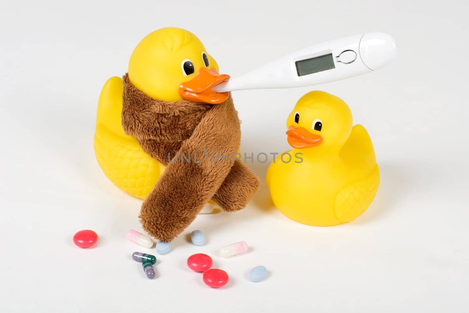 sick rubber ducks with clinical thermometer and tablets