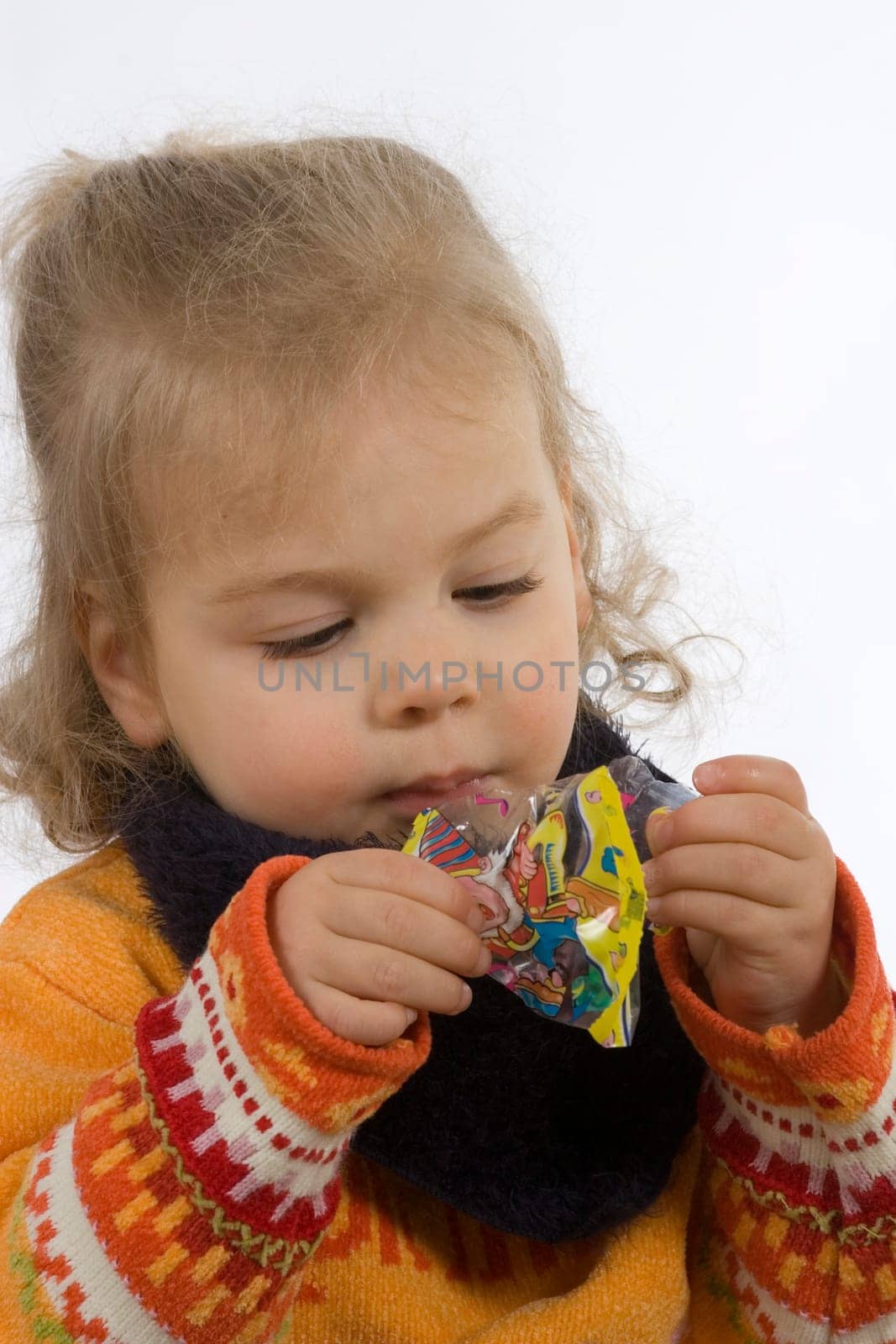 Child looks into an empty bag of sweets