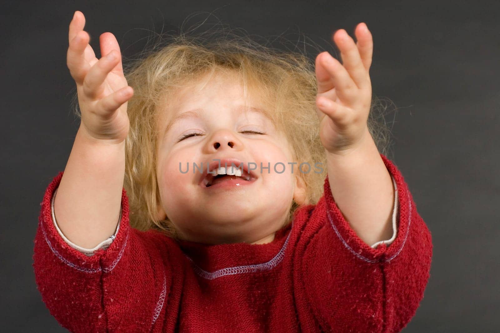 Child stretches his arms to the sky