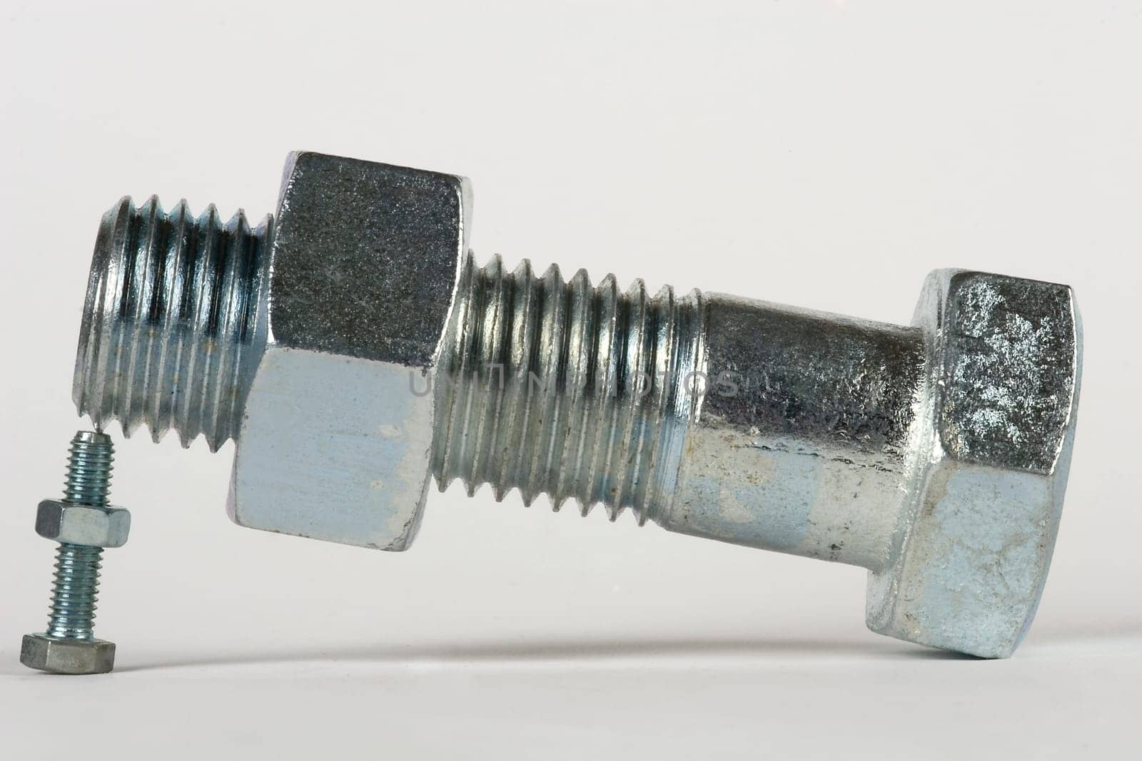 a large screw is supported by a small screw
